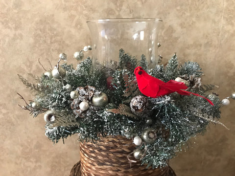 Snow covered centerpiece in bronze/clear candle holder and cardinal