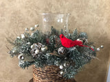 Snow covered centerpiece in bronze/clear candle holder and cardinal