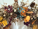 Bronze leaves, gold ranaculus and blueberries