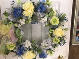 White evergreen wreath with large yellow peony’s