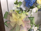 White evergreen wreath with large yellow peony’s