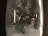 Snowman on a vase with a woodsy scene