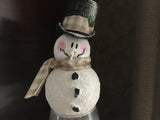 Snowman on a vase with a woodsy scene