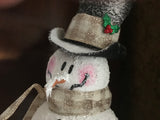 Snowman on a vase with a woodsy scene