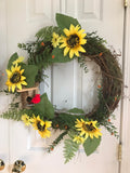 Sunflowers and a handcrafted birdhouse