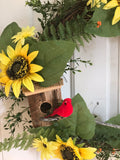 Sunflowers and a handcrafted birdhouse